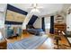 Well-lit bedroom with hardwood floors, map wall decor, and a blue area rug at 709 Bonhurst Dr, Holly Springs, NC 27540