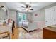 Cozy bedroom featuring a ceiling fan, a comfortable single bed, and hardwood floors at 709 Bonhurst Dr, Holly Springs, NC 27540