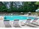 Relaxing community pool with lounge chairs and umbrellas at 709 Bonhurst Dr, Holly Springs, NC 27540