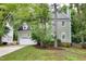 Charming two-story home with a lush green lawn and attached two car garage at 709 Bonhurst Dr, Holly Springs, NC 27540