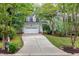 Two-story home with a long driveway leading up to a two-car garage at 709 Bonhurst Dr, Holly Springs, NC 27540