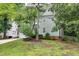 Charming two-story home with a lush front lawn and mature trees, showcasing curb appeal at 709 Bonhurst Dr, Holly Springs, NC 27540