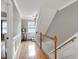 Open foyer featuring hardwood floors, white wainscoting, and staircase access at 709 Bonhurst Dr, Holly Springs, NC 27540