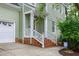 Charming front porch with brick steps and white wooden railing at 709 Bonhurst Dr, Holly Springs, NC 27540