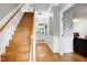 Open staircase that leads into a home hallway with views to the kitchen and living room at 709 Bonhurst Dr, Holly Springs, NC 27540