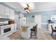 Bright kitchen with white cabinets, island, and stainless steel oven at 709 Bonhurst Dr, Holly Springs, NC 27540