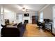 Open living room with hardwood flooring, fireplace, and lots of natural light at 709 Bonhurst Dr, Holly Springs, NC 27540