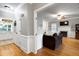 Open-concept living room with hardwood floors, fireplace, and white trim throughout at 709 Bonhurst Dr, Holly Springs, NC 27540