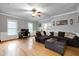 Large living room featuring hardwood floors, a ceiling fan, and natural lighting at 709 Bonhurst Dr, Holly Springs, NC 27540
