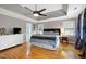 Large primary bedroom featuring a tray ceiling, ceiling fan, and ample natural light at 709 Bonhurst Dr, Holly Springs, NC 27540