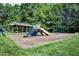Community playground with slides, swings, and a covered seating area, nestled among mature trees and green space at 709 Bonhurst Dr, Holly Springs, NC 27540