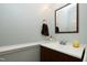 Convenient powder room featuring a vanity with modern fixtures and neutral decor at 709 Bonhurst Dr, Holly Springs, NC 27540