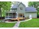 Rear of the property features a screened porch, wooden deck, and a well-manicured lawn at 709 Bonhurst Dr, Holly Springs, NC 27540