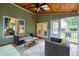 Cozy screened-in porch perfect for outdoor living, with comfortable seating area at 709 Bonhurst Dr, Holly Springs, NC 27540