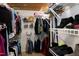 Organized walk-in closet with shelving and hanging racks for ample storage space at 709 Bonhurst Dr, Holly Springs, NC 27540