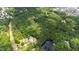 Aerial view shows heavily wooded lot with water and building at 7104 Camp Branch Ln, Apex, NC 27502