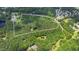 Aerial view of heavily wooded lot outlined in white with limited clearing for house at 7104 Camp Branch Ln, Apex, NC 27502