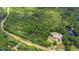 Aerial view shows heavily wooded lot with water and building at 7104 Camp Branch Ln, Apex, NC 27502
