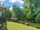 Expansive backyard with lush green lawn, mature trees, and a privacy fence, great for outdoor activities at 744 Birch Arbor Cir, Raleigh, NC 27604