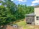 Spacious backyard featuring a patio, lush lawn, mature trees, and a screened porch, ideal for outdoor enjoyment at 744 Birch Arbor Cir, Raleigh, NC 27604