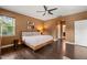 Spacious bedroom featuring hardwood floors, neutral decor, and access to an en-suite bathroom at 744 Birch Arbor Cir, Raleigh, NC 27604