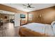 Comfortable bedroom with hardwood floors, mounted television, and views into the adjacent room at 744 Birch Arbor Cir, Raleigh, NC 27604