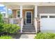 Charming front entrance with stone accents, a covered porch, and well-maintained landscaping at 744 Birch Arbor Cir, Raleigh, NC 27604