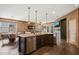 Open kitchen with center island, stainless dishwasher, and breakfast nook overlooking living area and fireplace at 744 Birch Arbor Cir, Raleigh, NC 27604