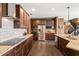 Beautiful kitchen boasts stainless appliances, granite counters, a 'Bar' area, and dark wood cabinetry at 744 Birch Arbor Cir, Raleigh, NC 27604