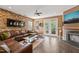 Inviting living area featuring a fireplace, brick wall, and access to an outdoor deck through glass doors at 744 Birch Arbor Cir, Raleigh, NC 27604