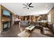 Open-concept living area boasts a fireplace, leather sectional sofa, and seamlessly connects to the kitchen at 744 Birch Arbor Cir, Raleigh, NC 27604