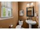 Powder room featuring a modern toilet, vanity, and neutral walls at 744 Birch Arbor Cir, Raleigh, NC 27604