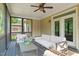 Relaxing screened porch features comfortable white couches and stylish decor, perfect for outdoor living at 744 Birch Arbor Cir, Raleigh, NC 27604
