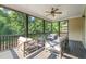 Inviting screened-in porch with comfortable seating and views of the green backyard at 744 Birch Arbor Cir, Raleigh, NC 27604