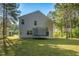 Large backyard with green grass, mature trees, and a trampoline at 98 Panmure, Rocky Mount, NC 27804