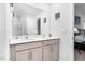 Bright bathroom featuring double sinks, white countertops and cabinets and a large mirror at 98 Panmure, Rocky Mount, NC 27804