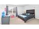 Bedroom features a dark wood bed frame, plush carpet, and a grey desk near a window at 98 Panmure, Rocky Mount, NC 27804