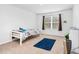Cozy bedroom featuring carpet, a window with blinds, and a small bed at 98 Panmure, Rocky Mount, NC 27804