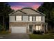 Charming two-story home showcasing stone accents, green shutters, and a well-manicured lawn at 98 Panmure, Rocky Mount, NC 27804