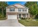 Charming two-story home showcasing stone accents, green shutters, and a well-manicured lawn at 98 Panmure, Rocky Mount, NC 27804