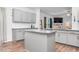 Kitchen island with granite countertops, stainless steel dishwasher, and an open view to the living area at 98 Panmure, Rocky Mount, NC 27804