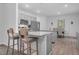 Open concept kitchen with an island, granite countertops, stainless steel appliances, and adjacent dining area at 98 Panmure, Rocky Mount, NC 27804
