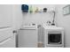 Bright laundry area featuring a washer, dryer, and storage shelf at 98 Panmure, Rocky Mount, NC 27804