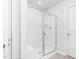 Modern bathroom featuring a glass-enclosed shower with a built-in seat and neutral toned tile flooring at 98 Panmure, Rocky Mount, NC 27804