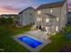 Aerial twilight view showcasing pool, screened porch, patio, and fenced-in yard at 98 Stone Bridge Xing # 98, Chapel Hill, NC 27517