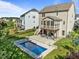 Aerial view of backyard showcasing pool, screened porch, patio, and fenced-in yard at 98 Stone Bridge Xing # 98, Chapel Hill, NC 27517