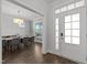 Welcoming entryway leading to a dining area with a modern chandelier and natural light at 98 Stone Bridge Xing # 98, Chapel Hill, NC 27517