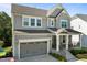 Attractive home featuring neutral siding, an attached garage, and a welcoming covered entryway at 98 Stone Bridge Xing # 98, Chapel Hill, NC 27517