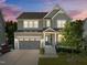 Charming two-story home showcasing neutral siding, an attached garage, and a welcoming front porch at 98 Stone Bridge Xing # 98, Chapel Hill, NC 27517