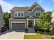 Charming two-story home showcasing neutral siding, an attached garage, and a welcoming front porch at 98 Stone Bridge Xing # 98, Chapel Hill, NC 27517